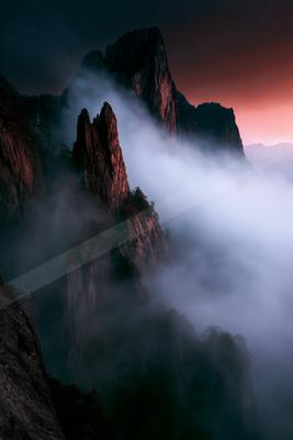 A moody landscape of mountains.