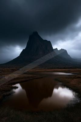 A night landscape of mountains, lake, storm.