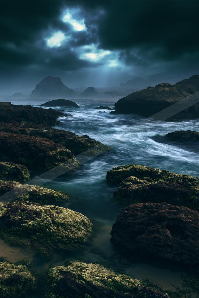 A night long exposure water scene of ocean, storm, rocks.