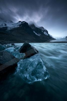 A blue hour long exposure water scene of ocean, lake, river.