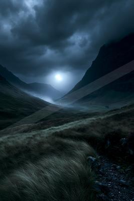 A black-toned moody photograph of valley, mountain tent, volcano.