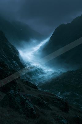 A night long exposure water scene of ocean, mountains, river.