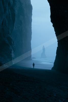 A moody water scene of ocean, beach.