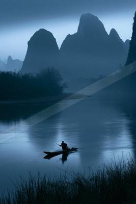 A serene water scene of lake, river, mountains.
