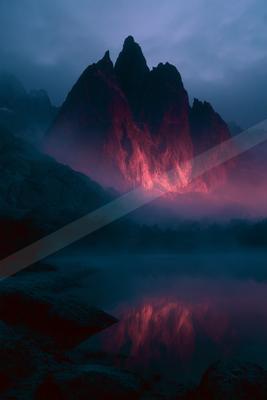 A blue hour landscape of mountains, lake.