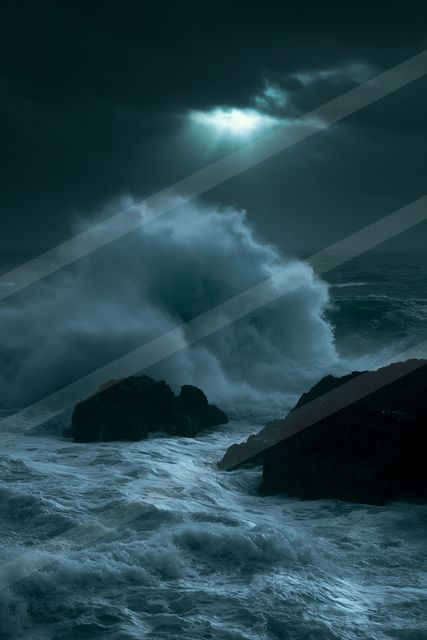 A powerful wave crashes against dark rocky cliffs under a moody sky, illuminated by a beam of light piercing through the clouds.