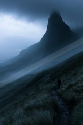 A moody landscape of mountains, valley.