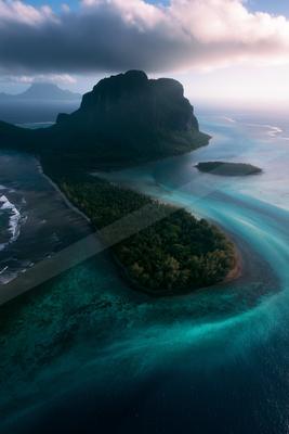 A black-toned moody photograph of coral reef, seashore, promontory.
