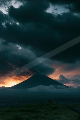 A dramatic sky scene of clouds, mountains, storm.