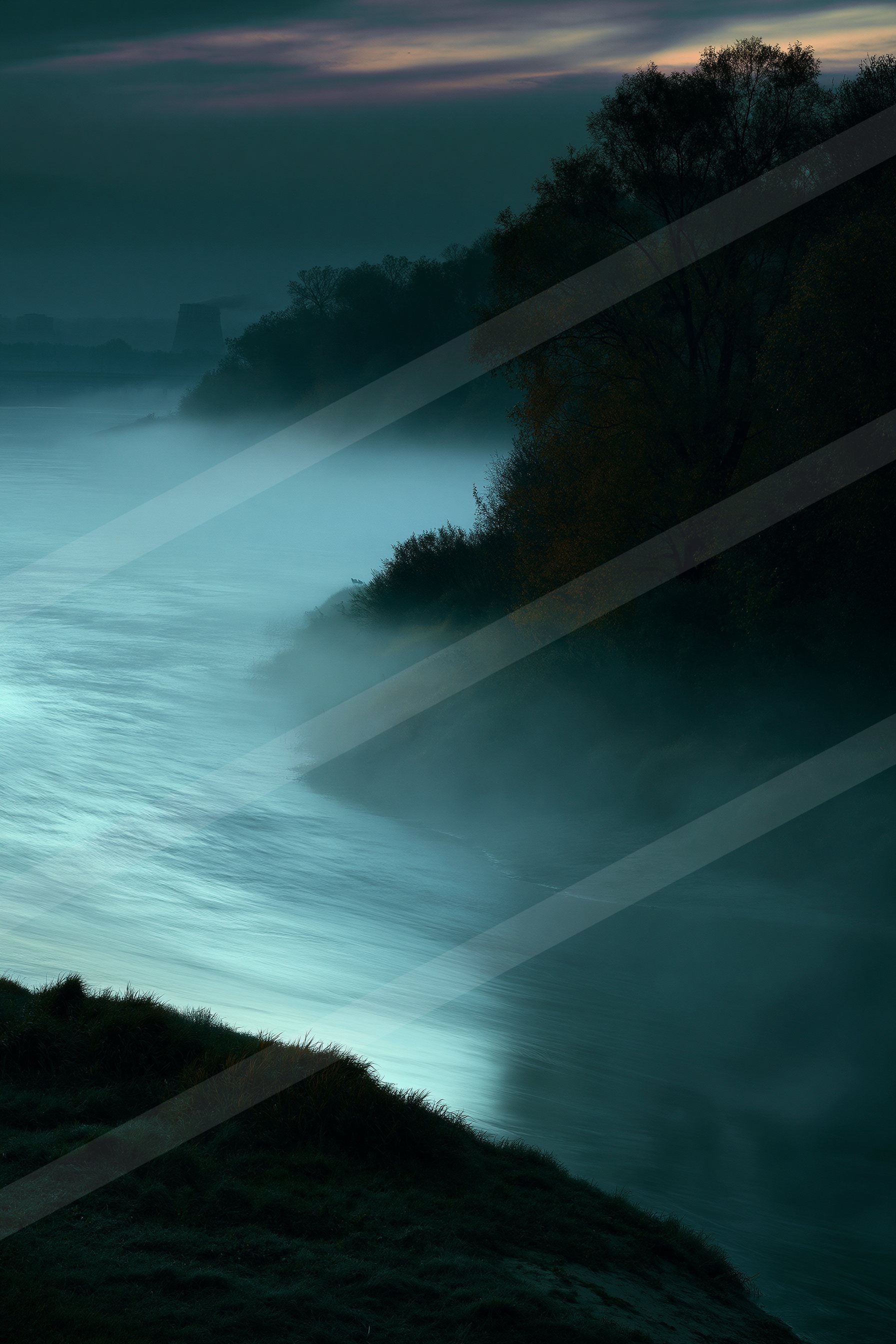 A blue hour long exposure water scene of a coastline, fog.