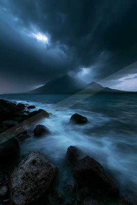 A night long exposure sky scene of storm, ocean, fog.