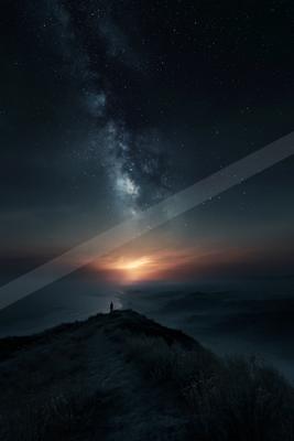 A lone silhouetted person stands on a grassy mountain ridge at night, gazing up at a brilliant Milky Way galaxy stretching across a star-filled sky, with a glow