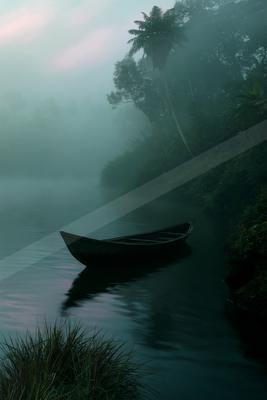 A black-toned moody photograph of canoe, lakeside, paddle.