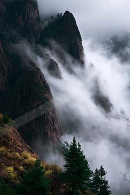 An ethereal high-key landscape of a mountains, fog.