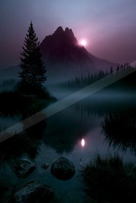 A night landscape of mountains, lake, sunrise.