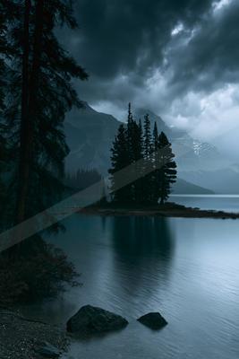 A night water scene of lake, storm, mountains.