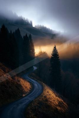 A dramatic long exposure landscape of mountains, valley, storm.