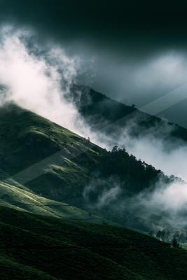 A gray-toned bright photograph of volcano, alp, valley.
