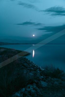 A blue hour long exposure water scene of lake, reflection.