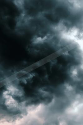 Moody and dramatic stormy clouds filling the sky with dark blue and grey tones