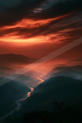 A moody sky scene of sunset, river, lake.