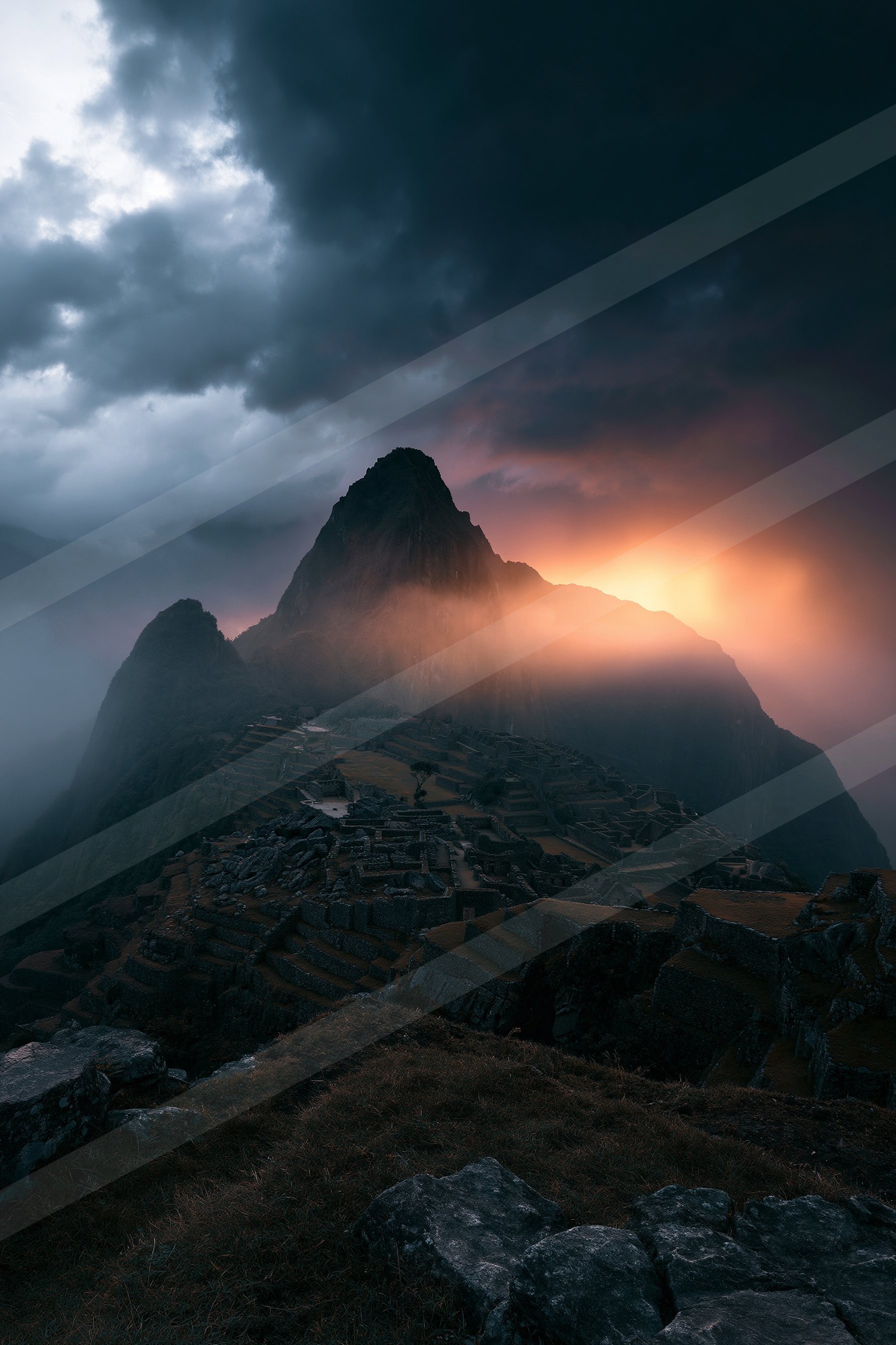 A breathtaking sunset illuminates ancient stone ruins surrounded by mist and dark, brooding clouds.