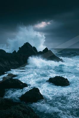 A bright water scene of ocean, storm, waterfall.