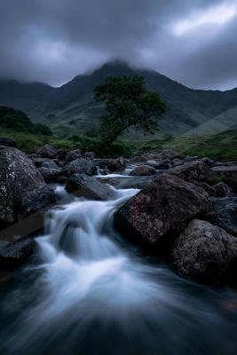 A serene long exposure water scene of river, waterfall, fog.