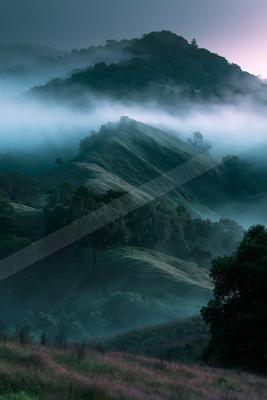 A black-toned moody photograph of volcano, alp, valley.