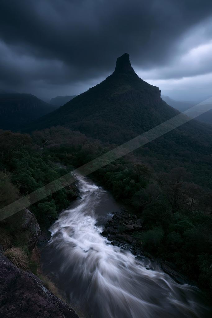 A night long exposure water scene of river, waterfall, mountains.