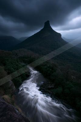 A night long exposure water scene of river, waterfall, mountains.
