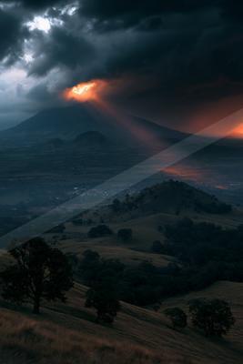 A dramatic sky scene of storm, valley, mountains.