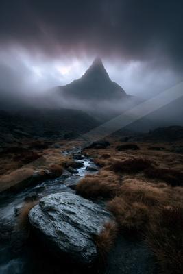 A mysterious long exposure landscape of a mountains, fog.