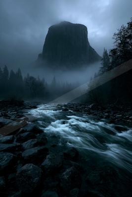 A serene landscape of mountains, river, waterfall.