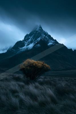 A black-toned moody photograph of volcano, alp, valley.