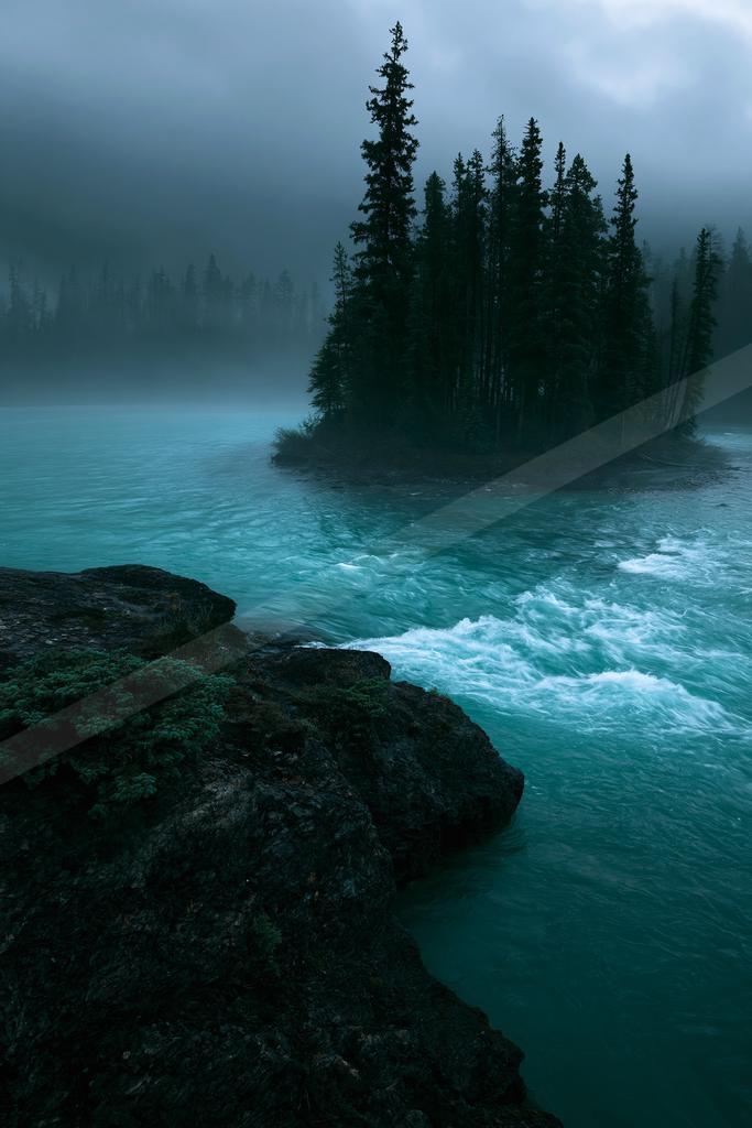 A green-toned moody photograph of lakeside, promontory, seashore.