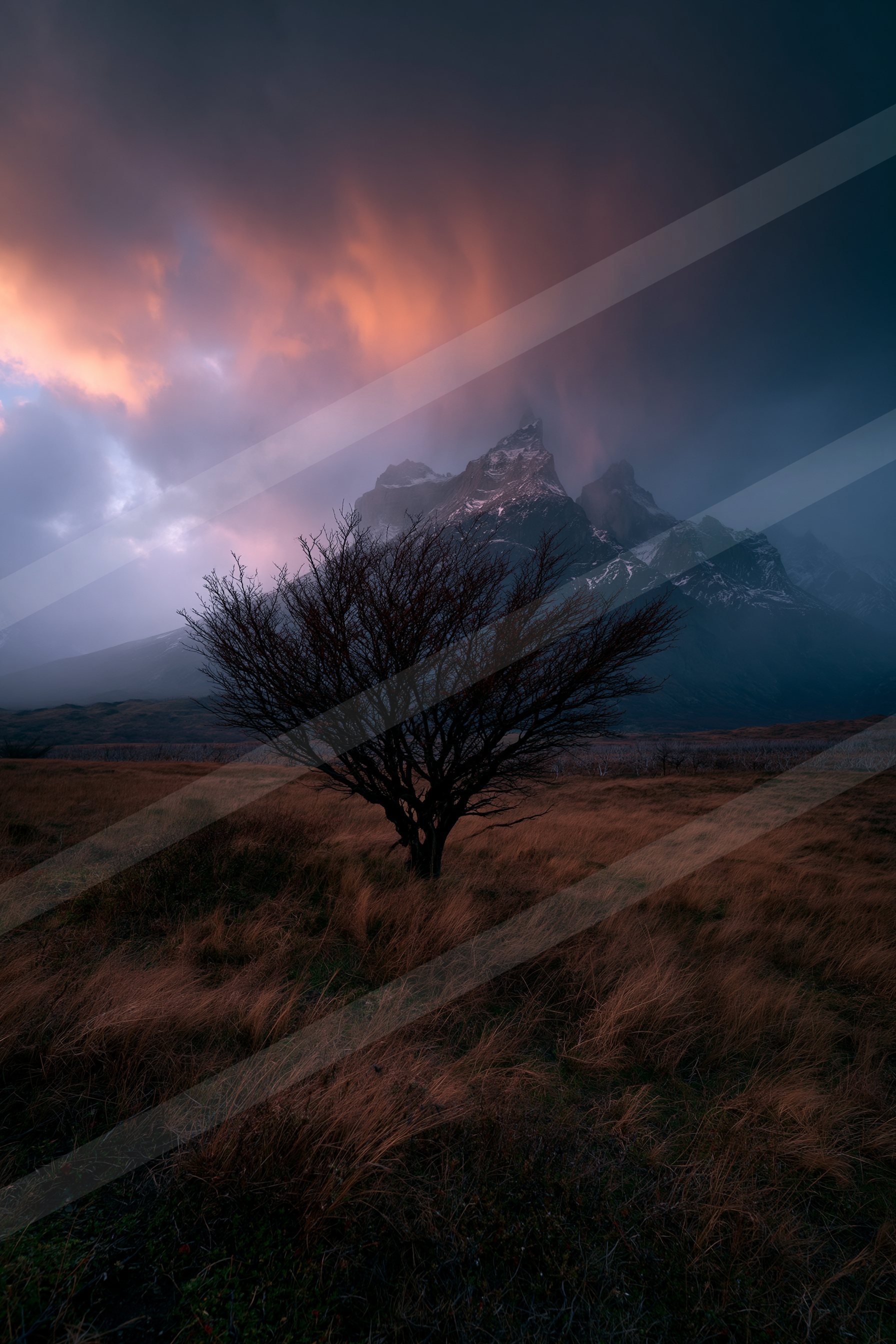 A dramatic high contrast landscape of a volcano, fog.