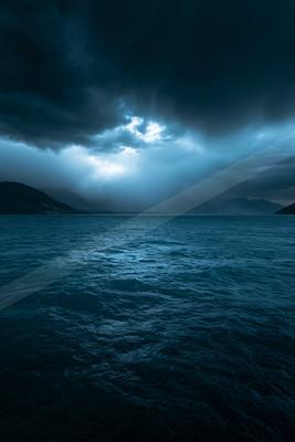 A blue hour long exposure water scene of ocean, storm.