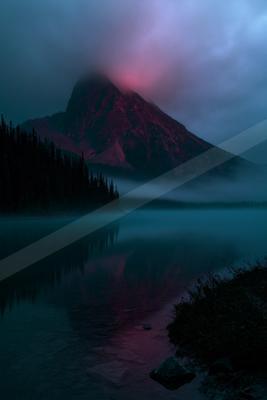 A black-toned moody photograph of volcano, alp, lakeside.