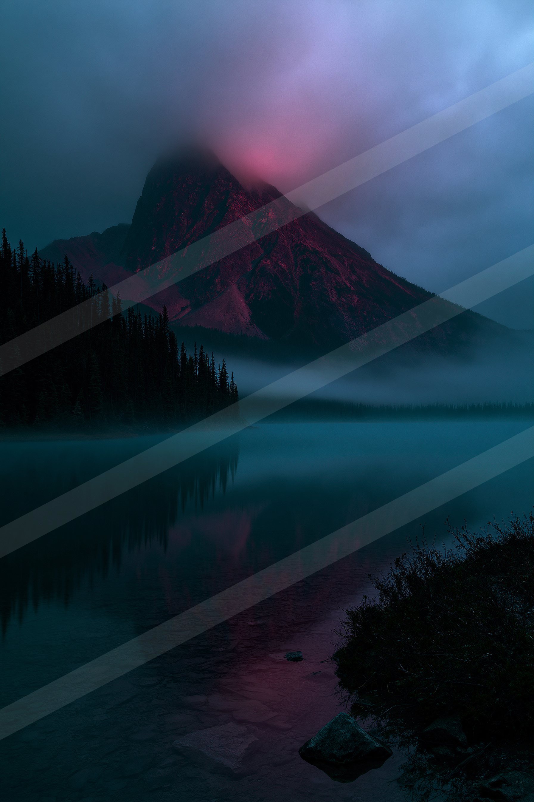 A serene lake reflects the silhouette of a mountain shrouded in mist, illuminated by an ethereal pink glow.