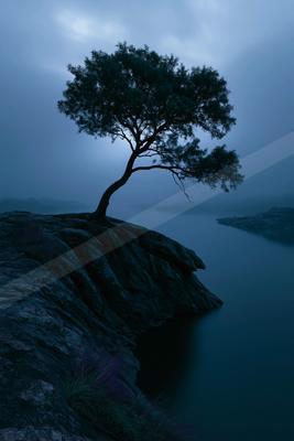 A blue hour water scene of lake, river, storm.
