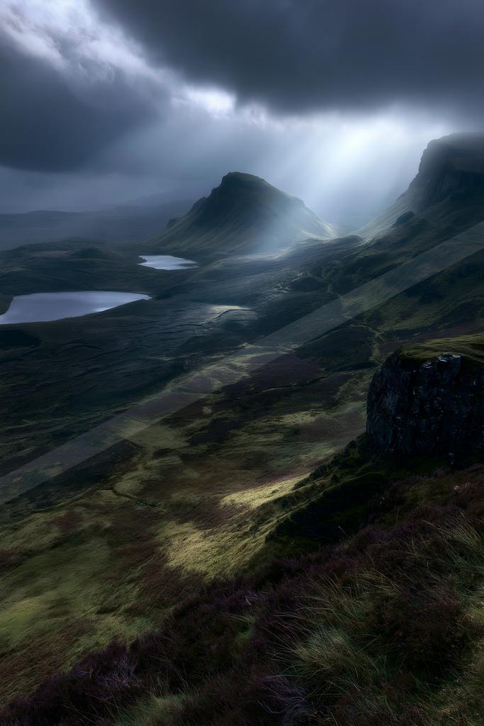 A dramatic landscape of valley, mountains, storm.