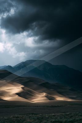 A dramatic landscape of desert, storm.
