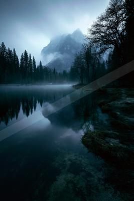 A blue hour water scene of lake, fog.