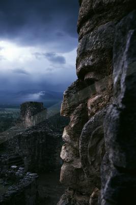 A dramatic landscape of valley, mountains, clouds.