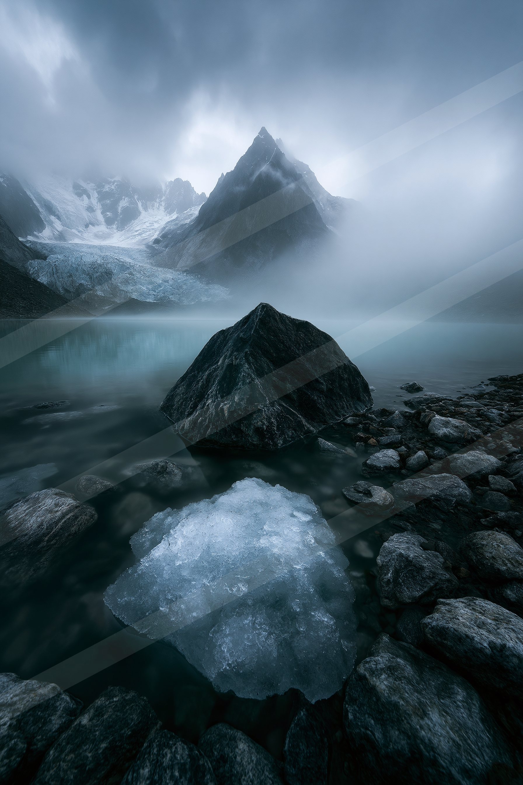 A serene glacier lake surrounded by rocky shores, featuring a floating iceberg and a majestic snow-capped mountain peak in the background.