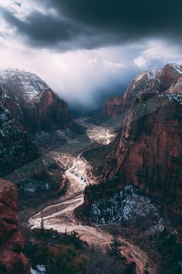 A bright landscape of mountains, valley, storm.