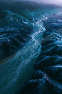 An ethereal aerial water scene of a river, ripples.