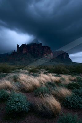 A black-toned moody photograph of cliff, valley, volcano.